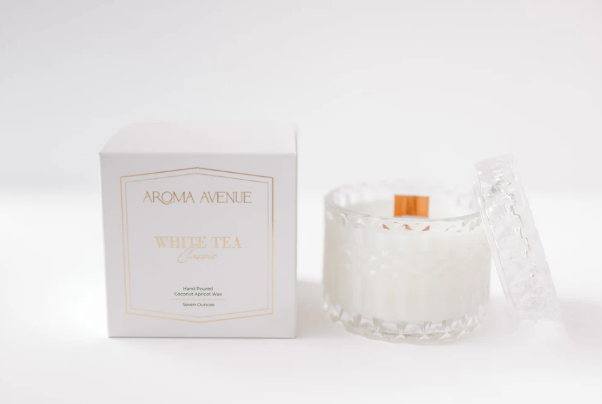 White tea scented candle in a textured glass jar with a matching lid and its white product box