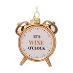 Glass ornament of a glittering gold alarm clock with a white face displaying the phrase It's Wine O'Clock in black and glitter gold text, topped with a small gold star charm