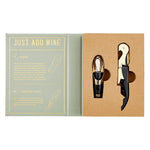 Wine accessory gift set featuring a gold and black wine pourer and corkscrew opener displayed in an open light green gift box with "JUST ADD WINE" text and instructional diagrams