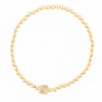 Gold beaded bracelet with a square charm featuring the letter J in crystals