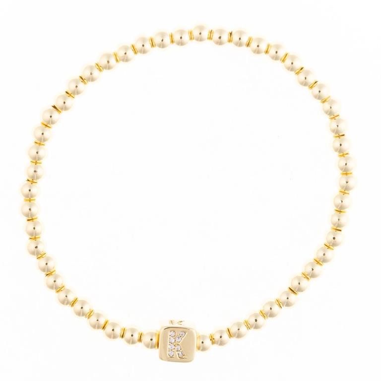Gold beaded stretch bracelet with a square charm featuring the letter K encrusted with small clear stones