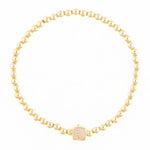 Gold beaded bracelet with a square charm featuring the letter L in diamonds