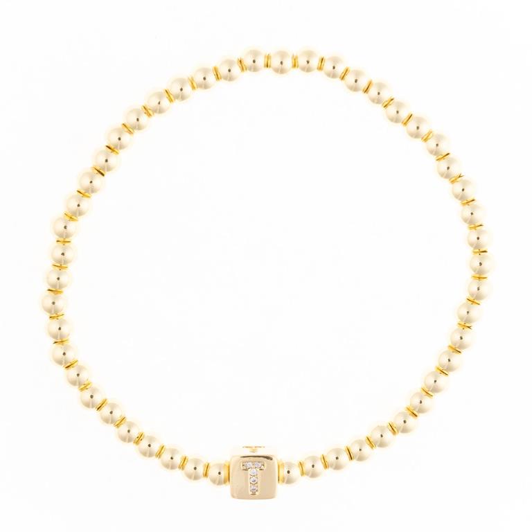 Gold beaded bracelet with a square charm featuring the letter T in crystals