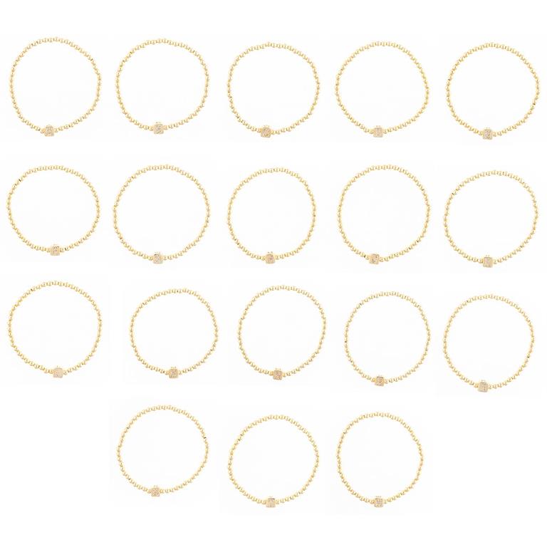 Collection of seventeen gold beaded rings with small square letter charms