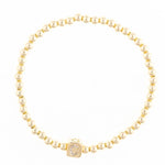 Gold beaded stretch bracelet with a square charm featuring a crystal letter C