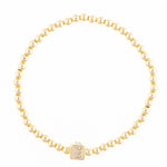 Gold beaded bracelet with a square charm featuring the letter E in crystals