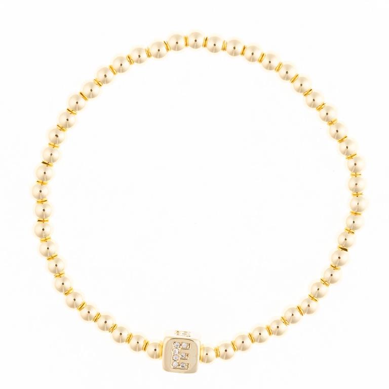 Gold beaded bracelet with a square charm featuring the letter E in crystals