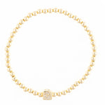 Gold beaded stretch bracelet with a square charm featuring a diamond letter G