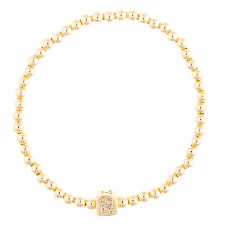 Gold beaded stretch bracelet with a square charm featuring the letter H in crystals