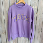 Purple sweatshirt with 'TIGERS' text on a wooden background