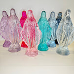 Colorful statues of a religious figure on a white background