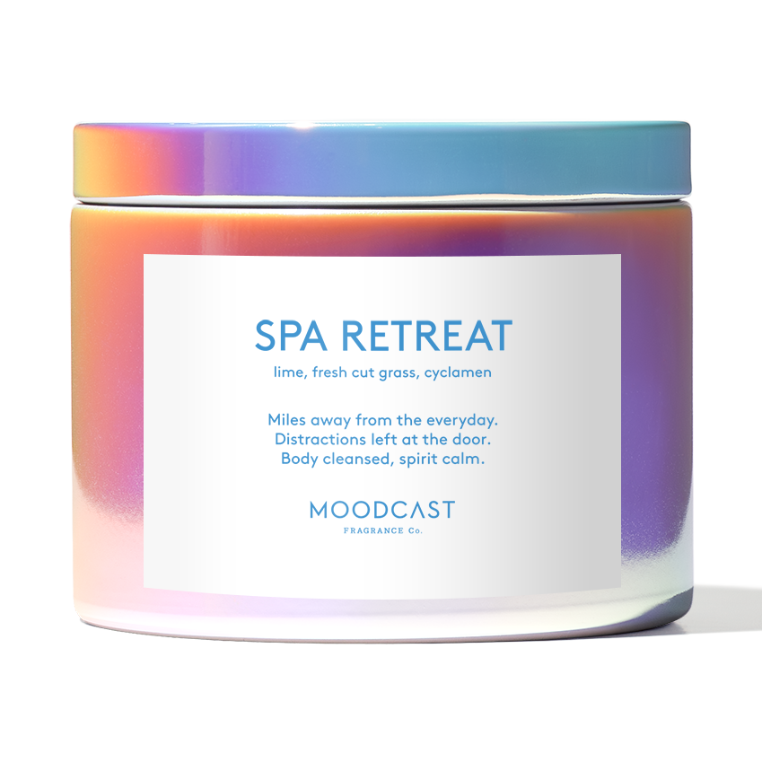 Iridescent candle jar labeled Spa Retreat with lime fresh cut grass and cyclamen scent notes