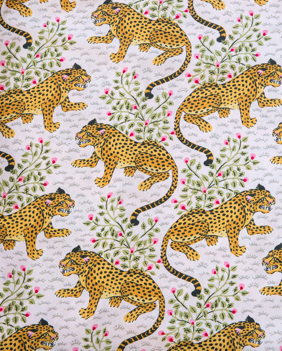 Pattern of leopards and floral vines on a white background