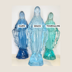 Three blue acrylic statues labeled 'Maris', 'Grace', and 'Tourmaline' on a white background.