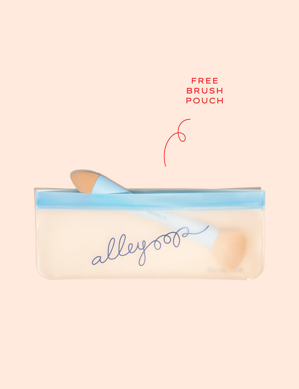 Makeup brush inside a translucent blue zippered pouch