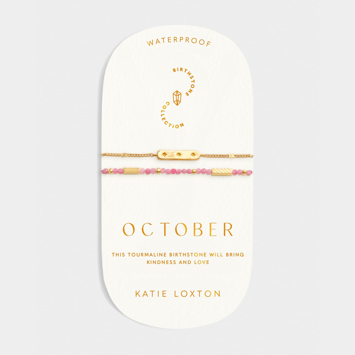 October birthstone bracelet set with pink tourmaline beads and gold bar charms on a display card