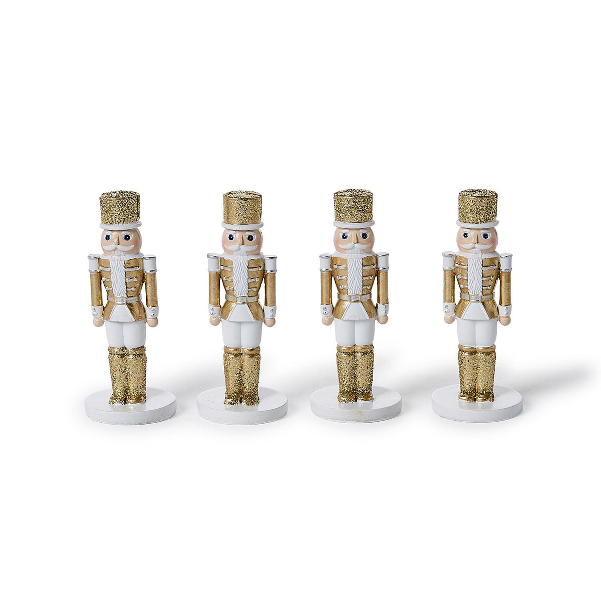 Four white and gold glitter nutcracker place card holders in a row