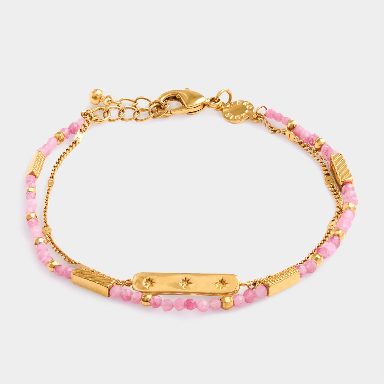 Gold chain bracelet with pink beaded strands and a central rectangular plate featuring three star engravings