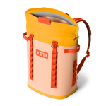 Yellow and peach backpack with orange accents on a white background, featuring the YETI logo.
