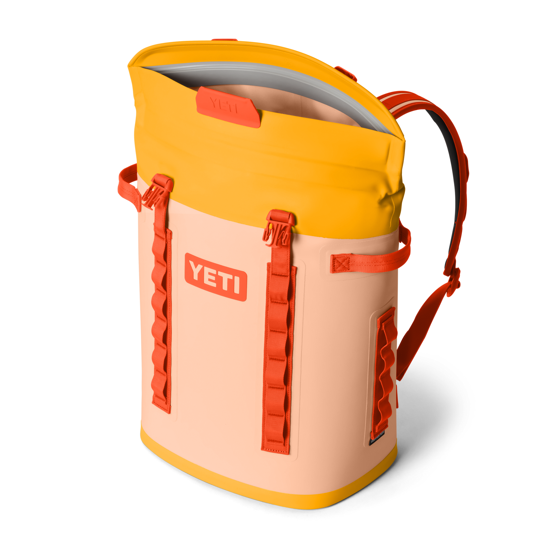 Yellow and peach backpack with orange accents on a white background, featuring the YETI logo.