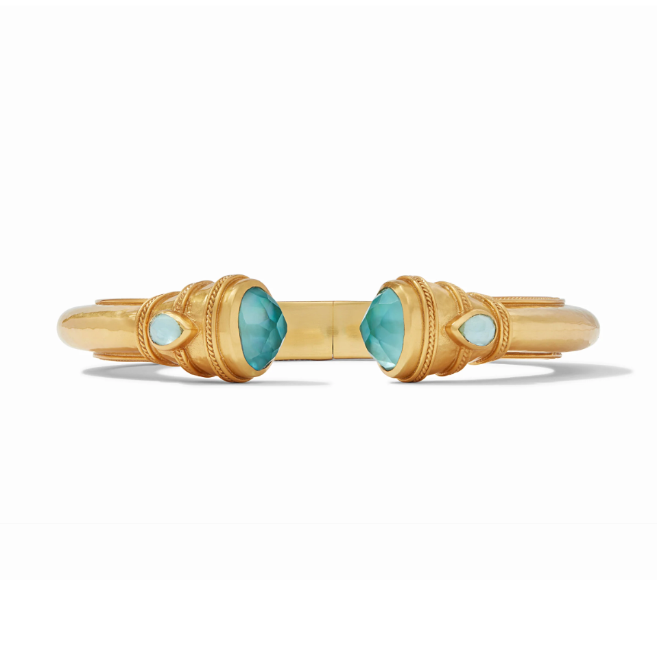 Gold cuff bracelet with two large teal faceted stones and two smaller teardrop teal stones