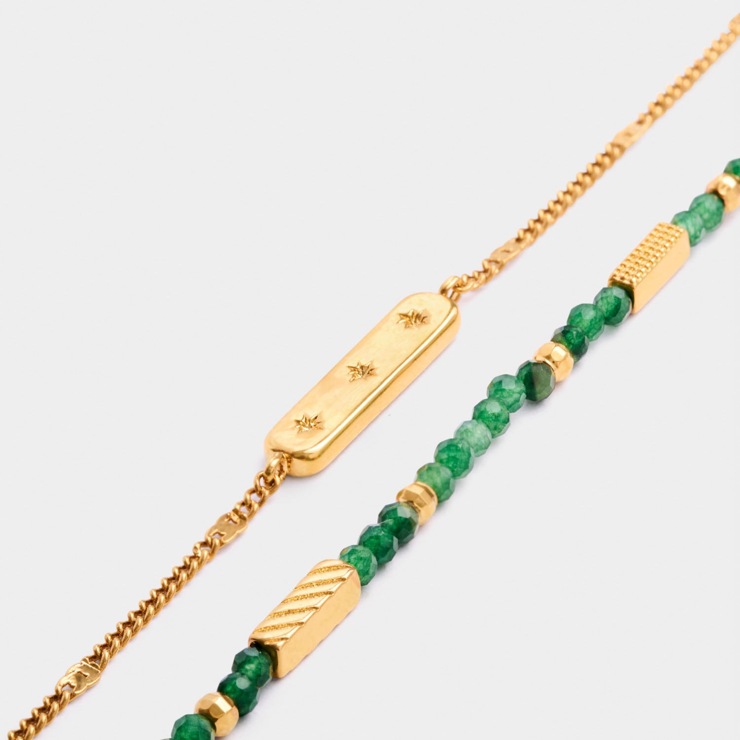 Gold chain bracelet with star engraved bar and beaded bracelet with green stones and gold accents