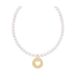 White pearl necklace with a gold circular pendant featuring a heart cutout