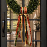 Sash of copper, olive velvet, gold satin and champagne ribbons on a boxwood wreath on a black door