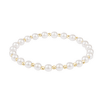 Stretch bracelet featuring alternating white pearls and small gold beads