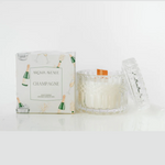 Candle with packaging labeled 'Champagne' by Aroma Avenue on a white background