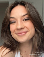 Close up portrait of a woman with brown hair wearing neutral makeup