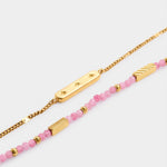Gold chain bracelet with star engraved bar and beaded bracelet with pink stones and gold accents