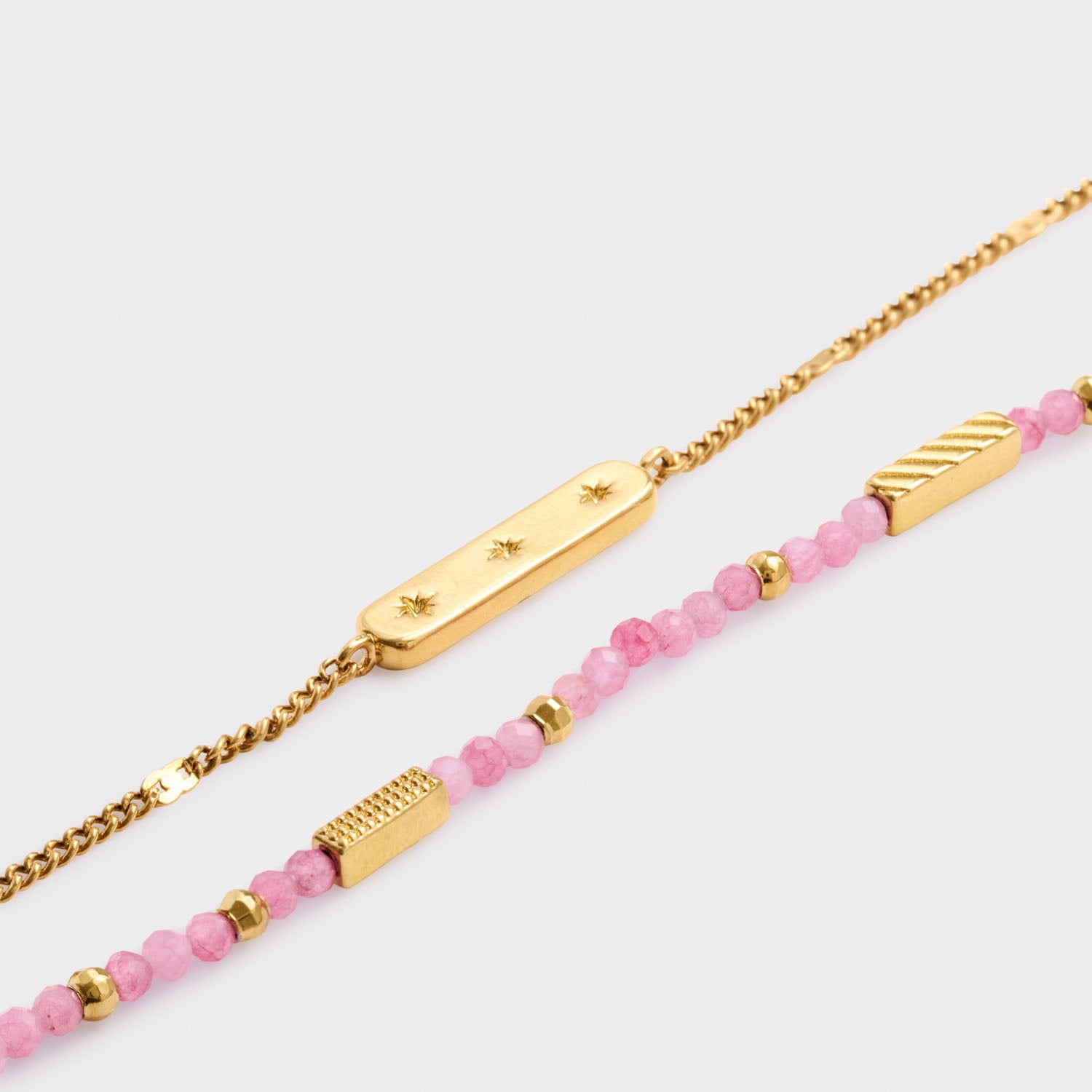 Gold chain bracelet with star engraved bar and beaded bracelet with pink stones and gold accents