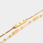 Gold chain bracelet with star engraved bar and beaded bracelet with gold accents