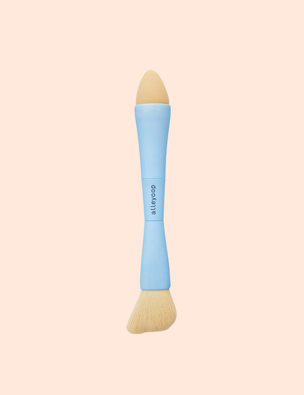 Dual ended makeup brush with a sponge tip and an angled bristle brush