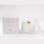 Aroma Avenue white tea candle and packaging on a white background