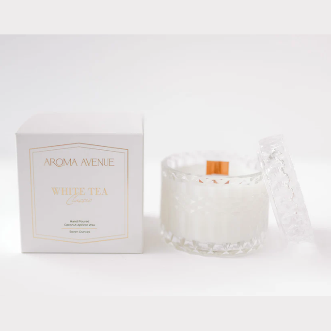 Aroma Avenue white tea candle and packaging on a white background
