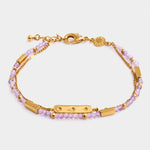 Gold chain bracelet with purple beaded strands and star engraved bar charm