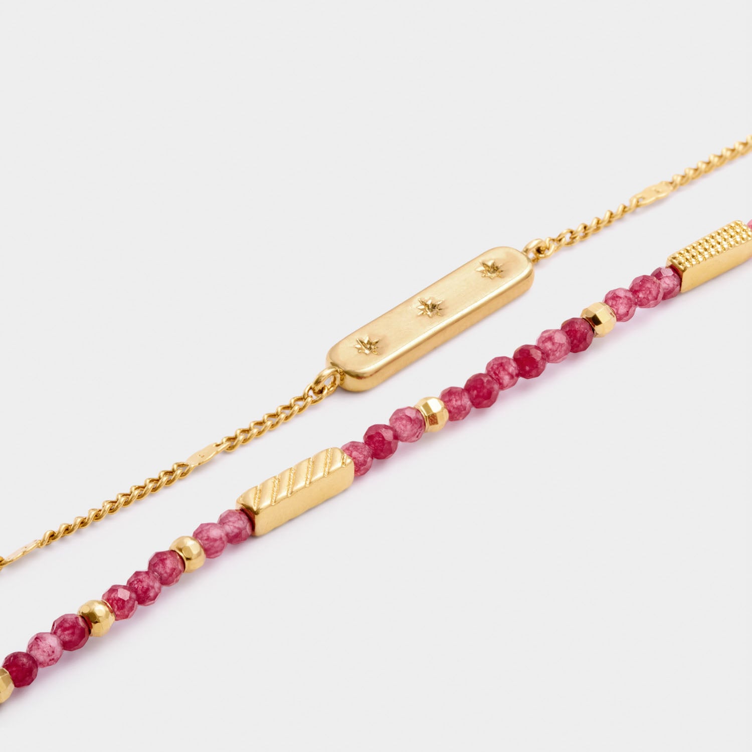 Gold chain bracelet with star engraved bar and beaded bracelet with pink gemstones and gold accents