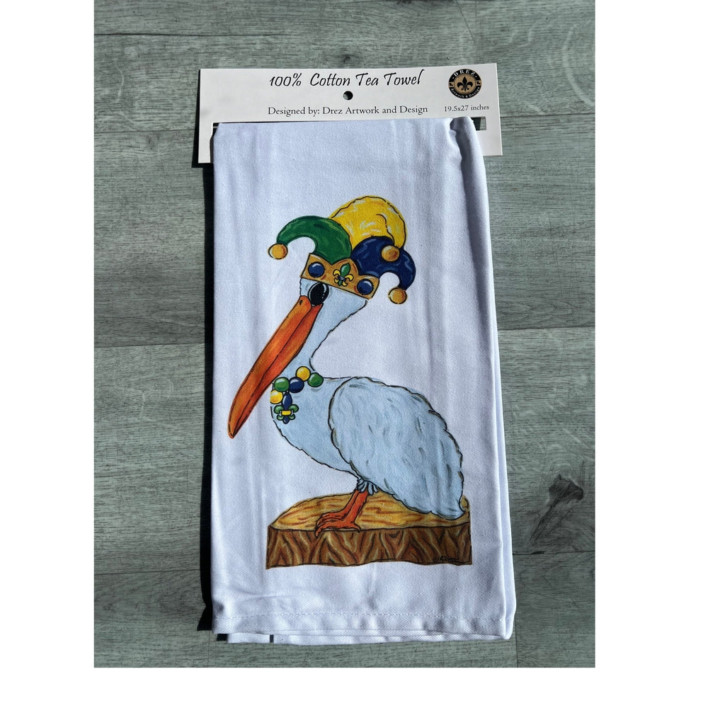 Tea towel with a pelican wearing a jester hat in its package