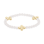 White pearl bracelet with three gold flower shaped bead clusters