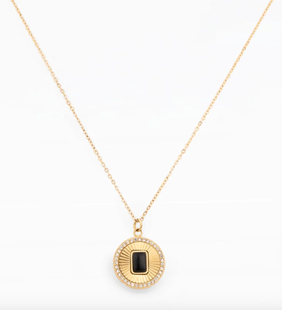 Gold chain necklace with a round pendant and black stone