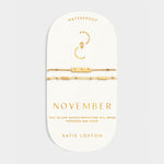 November birthstone bracelet set with yellow quartz beads and gold bar charm on display card
