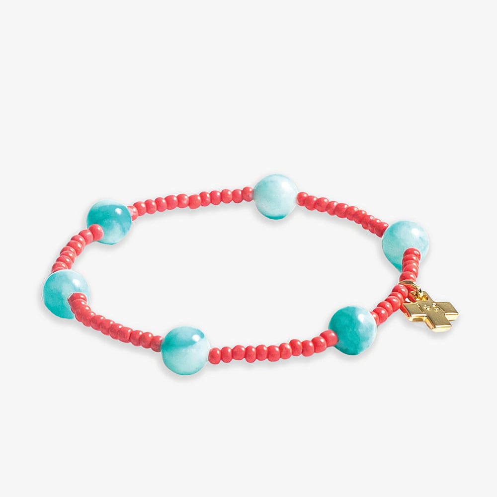 A vibrant beaded bracelet featuring small red seed beads strung with five larger round light blue beads and a delicate golden cross charm
