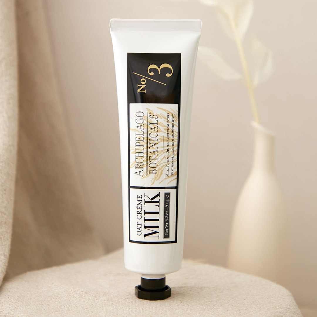 Oat Milk Hand Crème tube on a decorative background.