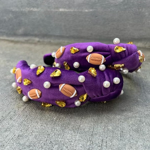 A purple headband with a football design, featuring gold-colored beads and pearls.