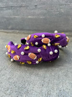 A purple headband with a football design, featuring gold-colored beads and pearls.