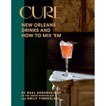 The cover of the book 'Cure: New Orleans Drinks and How to Mix 'Em' features an image of a cocktail glass on a blurred background.