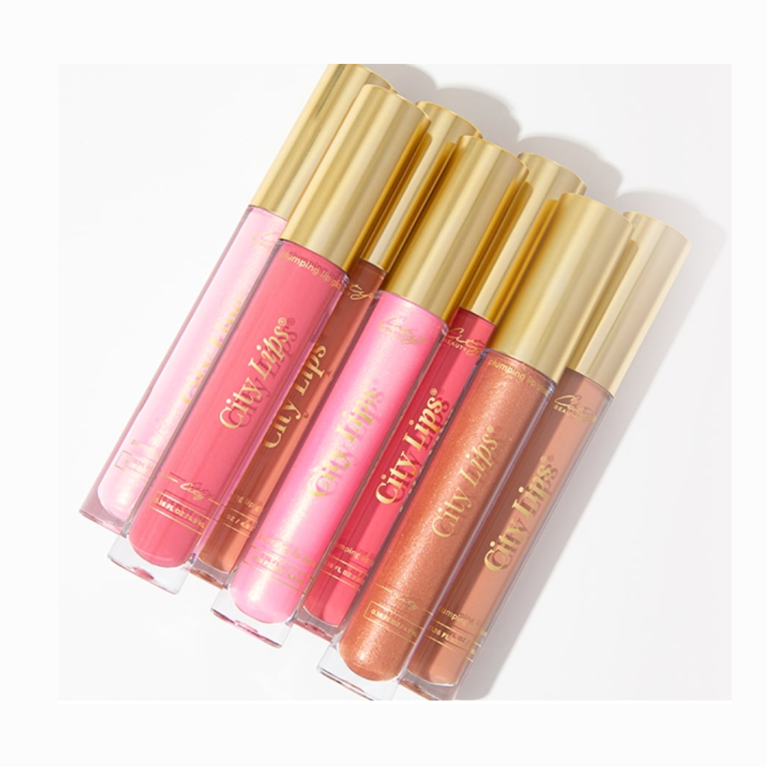A collection of five City Lips lip gloss tubes in various shades, with gold-colored caps.