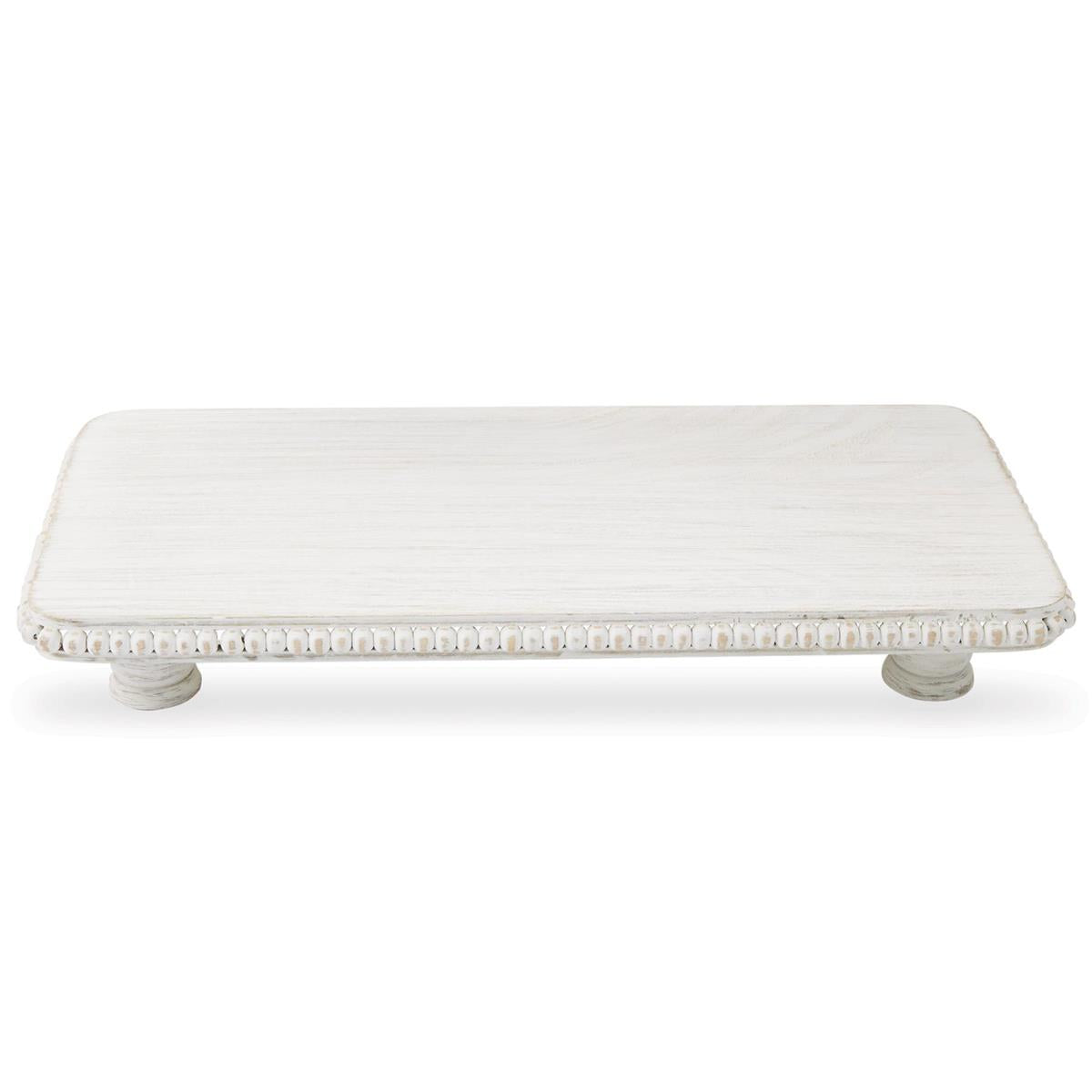 White distressed wooden rectangular pedestal tray featuring a decorative beaded edge and two small turned feet